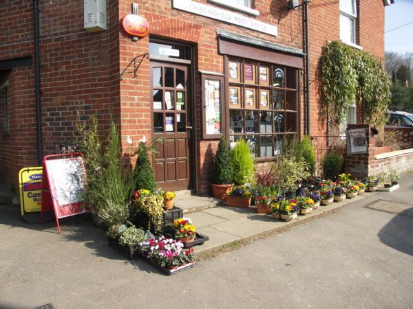 Chiddingfold Post Office with display  of flowers for sale