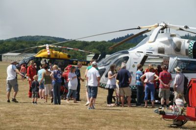 2 helicopters  and crowd of people
