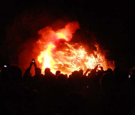 Bonfire burning with crowd of people
