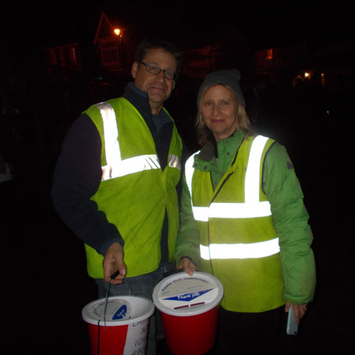 2 people with charity collection buckets