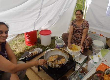 Cooking Indian food behind food stall