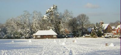 Snowmen  on cricket pitch  -  blue sky  - sun shining