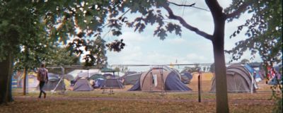 Foreground trees background tents